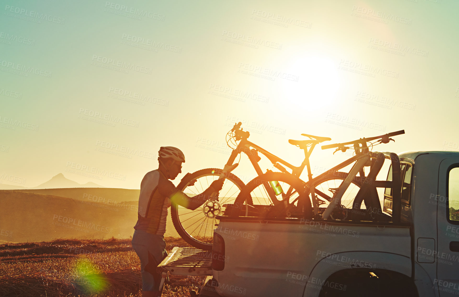 Buy stock photo Sports, morning and man with bicycle on car in nature for training, workout and exercise at sunrise. Fitness, cycling and mountain bike in truck for outdoor adventure, travel journey and transport