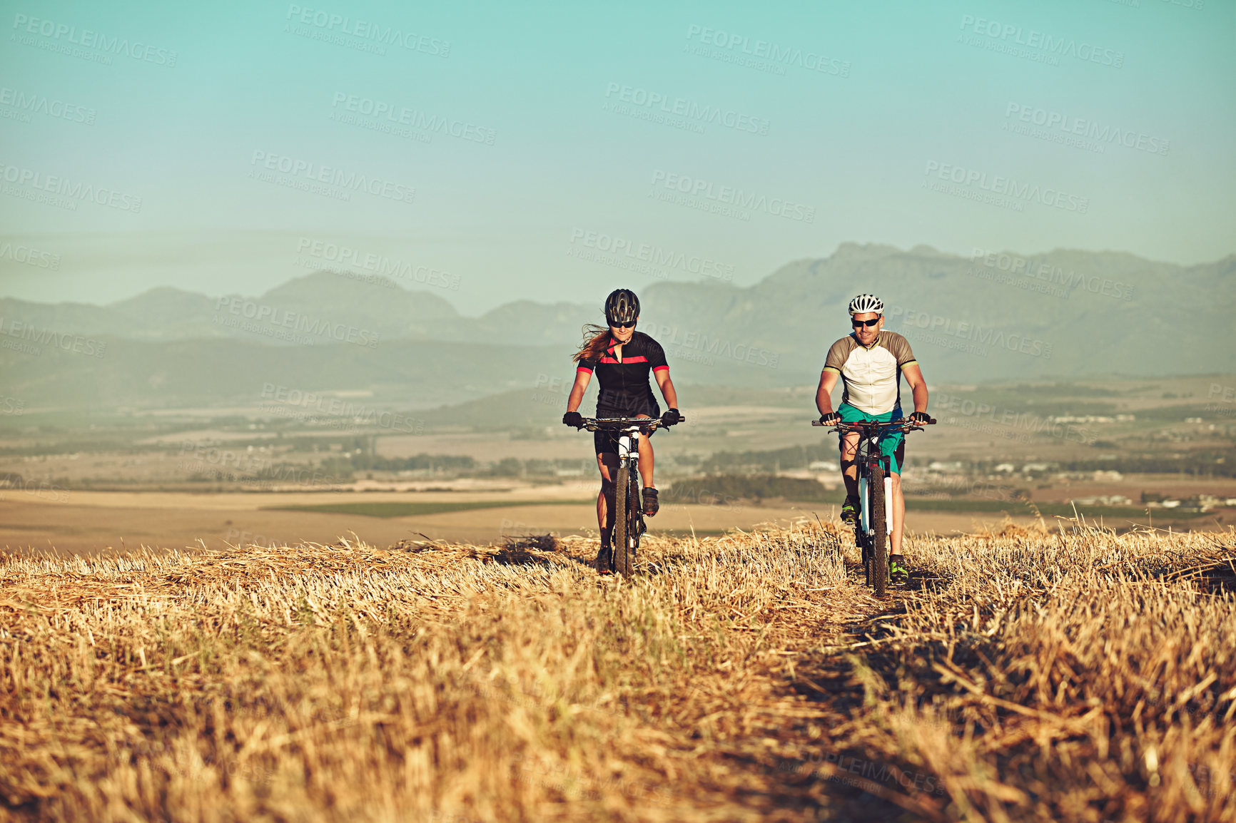 Buy stock photo Shot of two cyclists out cycling in the countryside