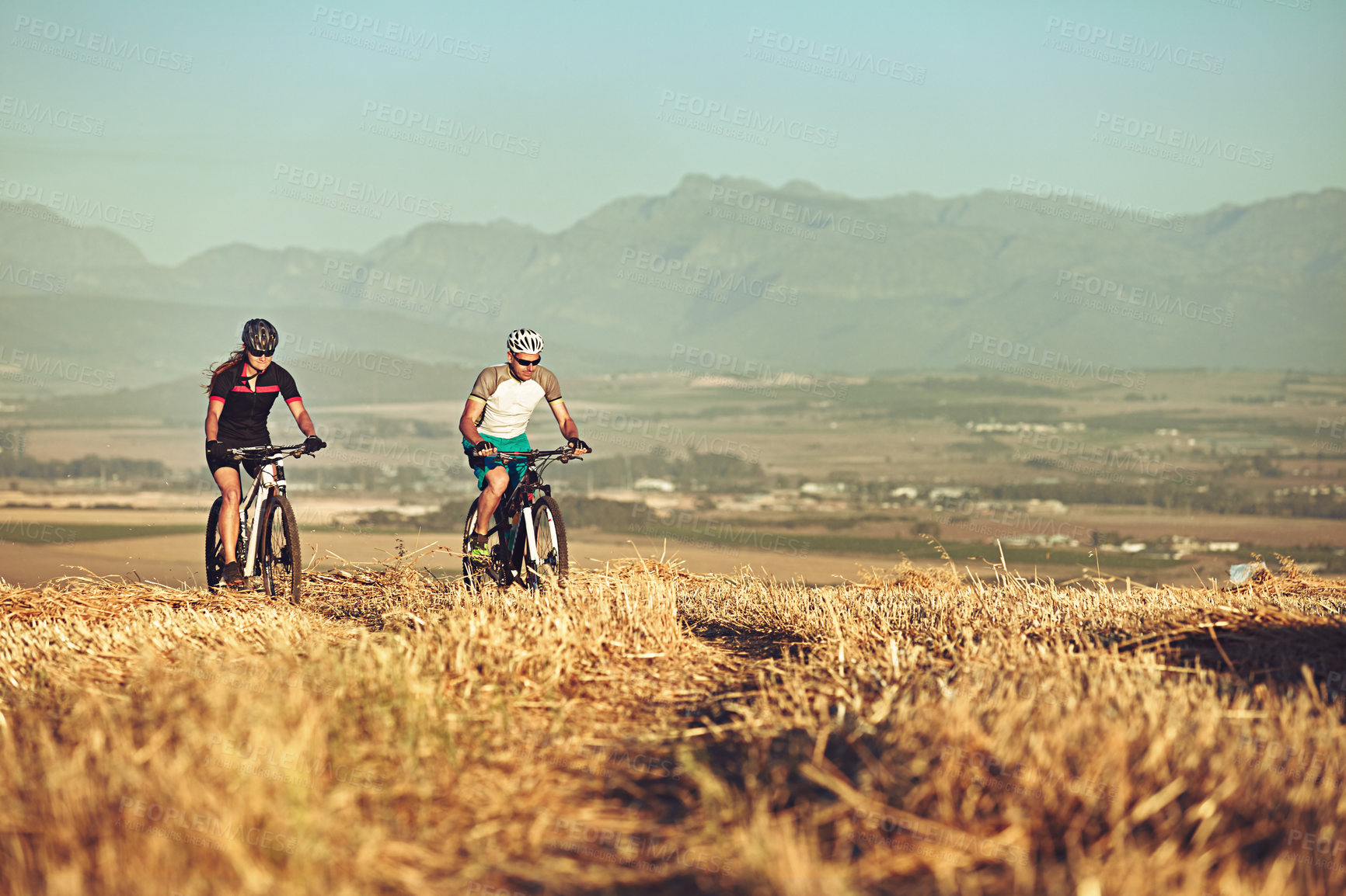 Buy stock photo Shot of two cyclists out cycling in the countryside