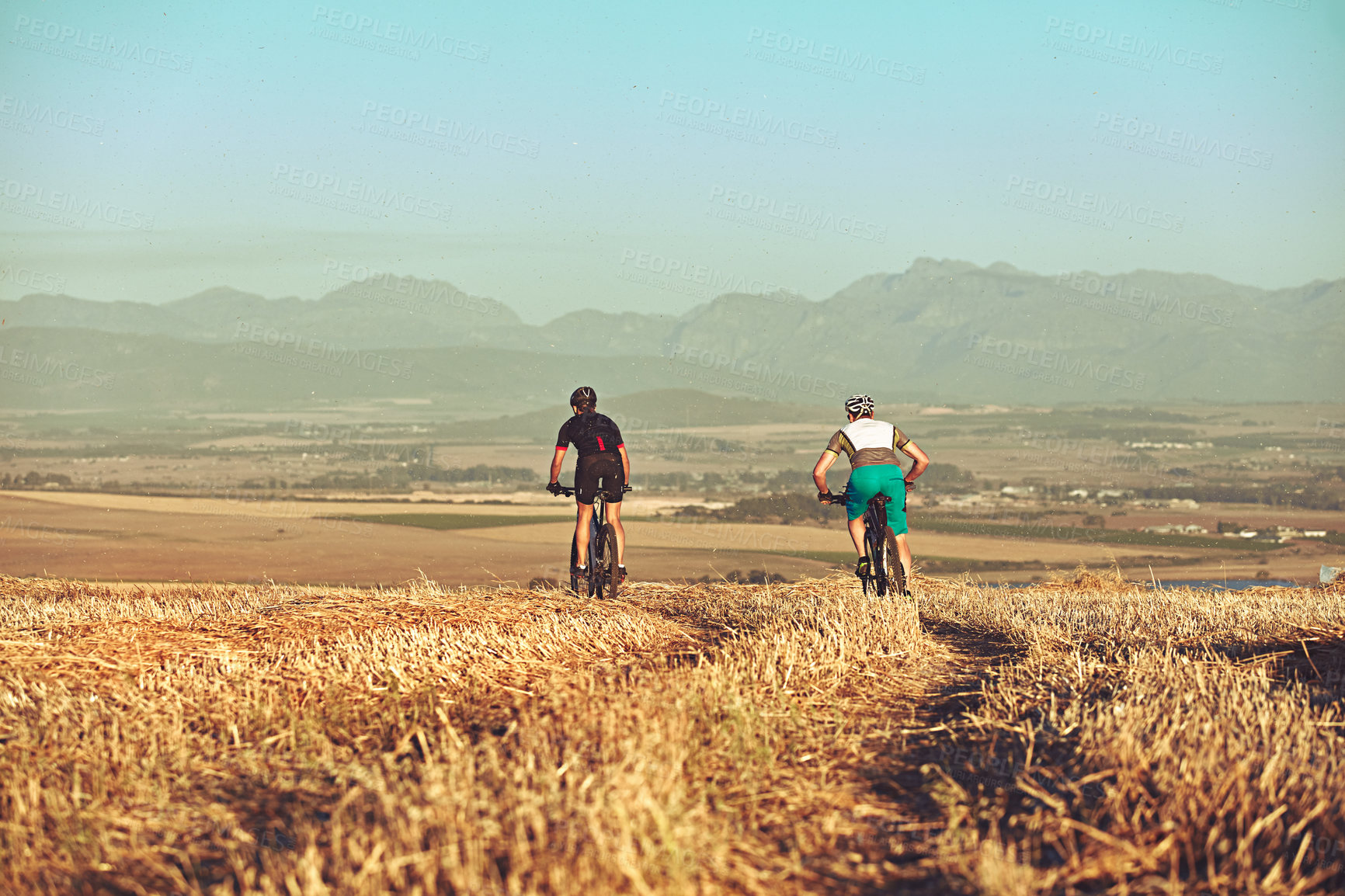 Buy stock photo Shot of two cyclists out cycling in the countryside