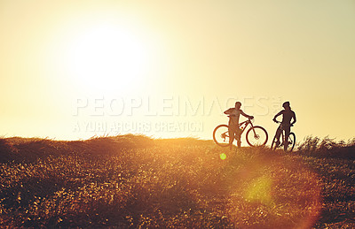 Buy stock photo Sunset, people and friends in bicycle race with lens flare, exercise and adventure trail in nature together. Cycling, fitness and team with mountain bike and evening for outdoor workout in silhouette