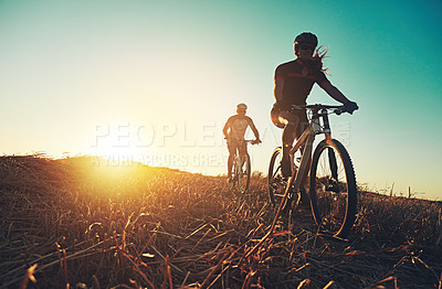 Buy stock photo Sunset sky, people and friends on bicycle with exercise, race and adventure trail in nature together. Cycling, fitness and team with mountain bike in evening for outdoor workout, sun and countryside