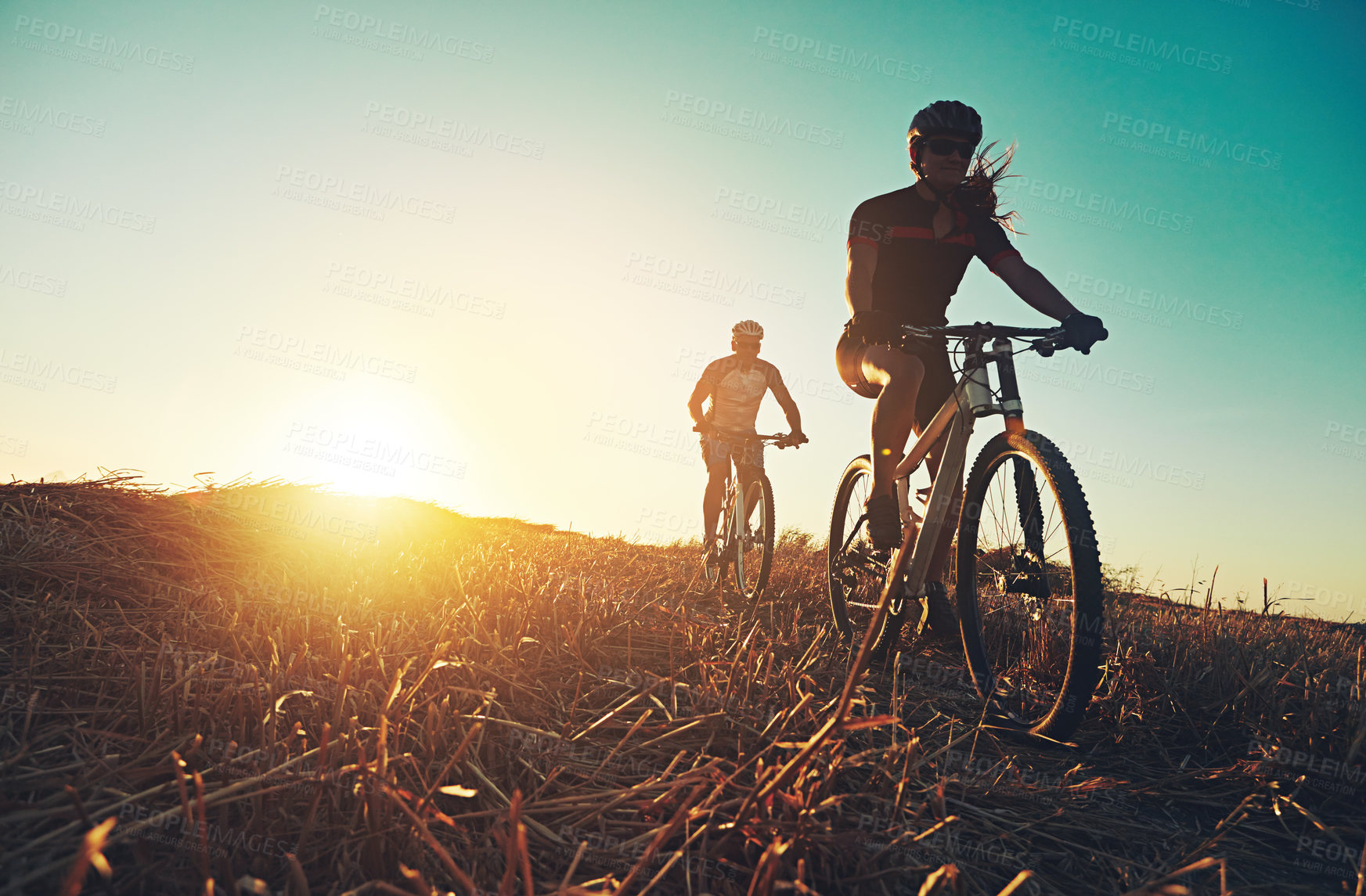 Buy stock photo Sunset sky, people and friends on bicycle with exercise, race and adventure trail in nature together. Cycling, fitness and team with mountain bike in evening for outdoor workout, sun and countryside