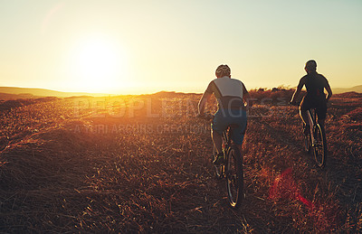 Buy stock photo Sunset, sky and friends in bicycle race with exercise, countryside and adventure trail in nature together. Cycling, fitness and people with mountain bike in evening for outdoor workout from back