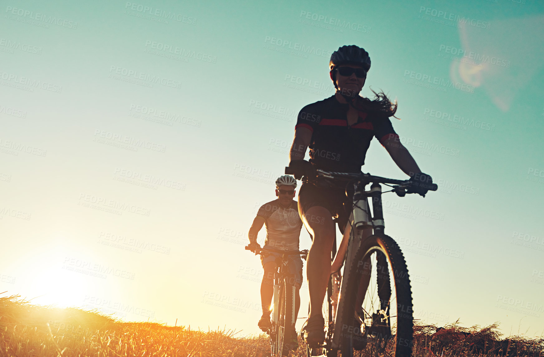 Buy stock photo Sunset, people and friends on bicycle with exercise, race and adventure trail in nature together. Cycling, fitness and team with mountain bike in evening for outdoor workout, sunshine and blue sky