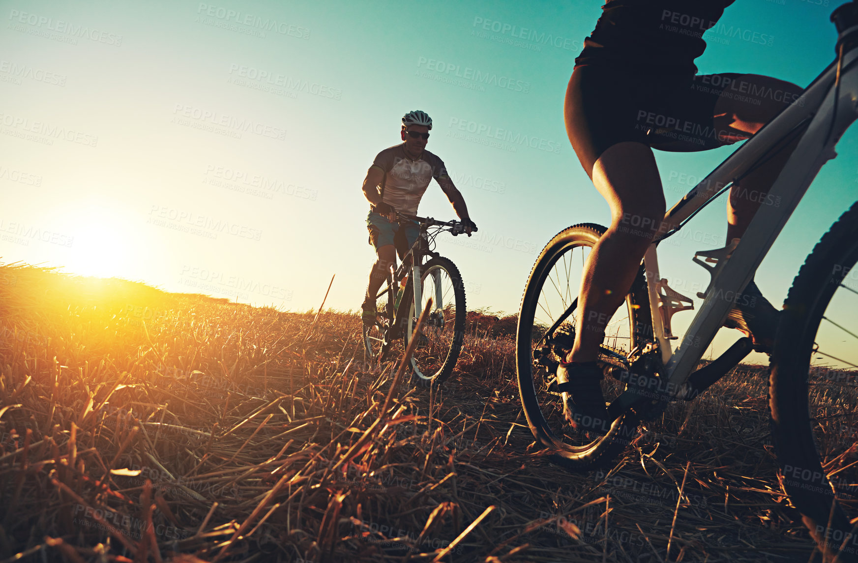 Buy stock photo Sunset sky, people and friends on bicycle with fitness, race and adventure trail in nature together. Cycling, exercise and team with mountain bike in evening for outdoor workout, sun and countryside