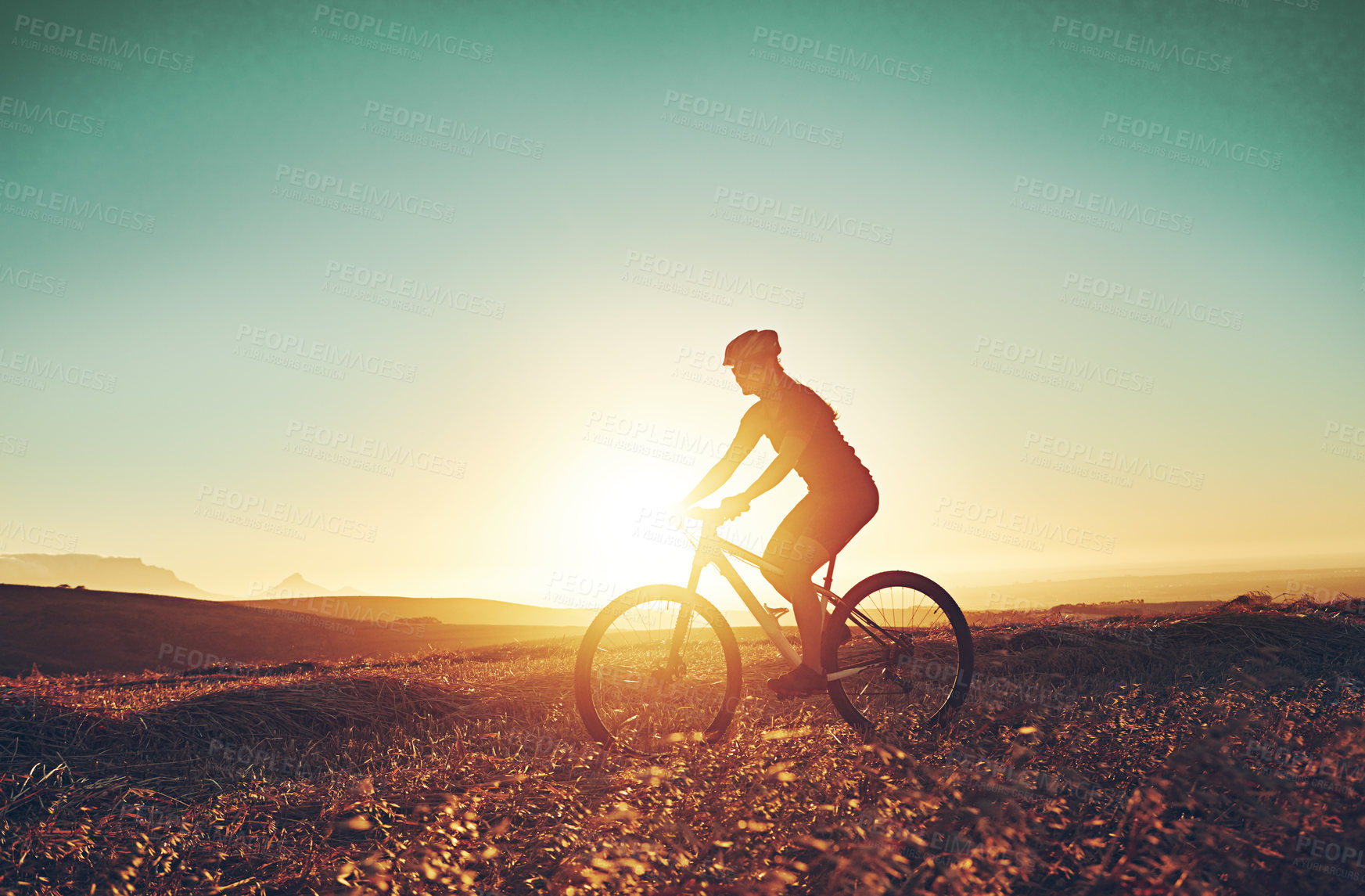 Buy stock photo Shot of an adventurous mountain biker out for a ride in the countryside