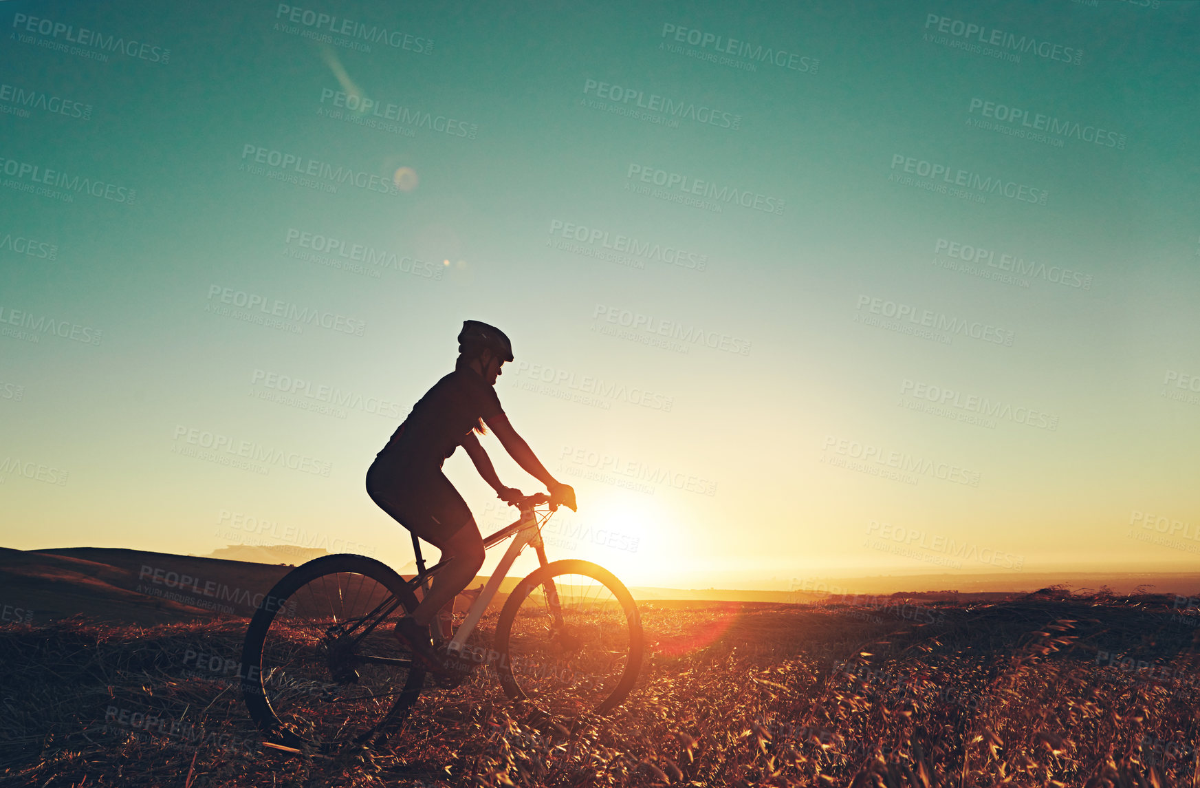 Buy stock photo Shot of an adventurous mountain biker out for a ride in the countryside