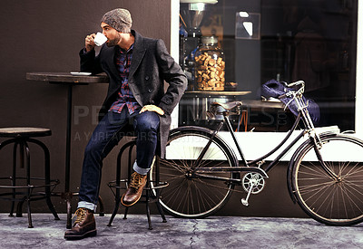 Buy stock photo Relax, cafe and man with a coffee, bike and fashion in the city, sustainable and carbon footprint. Male person, guy and biker with tea, street and outdoor with bicycle and eco friendly transport
