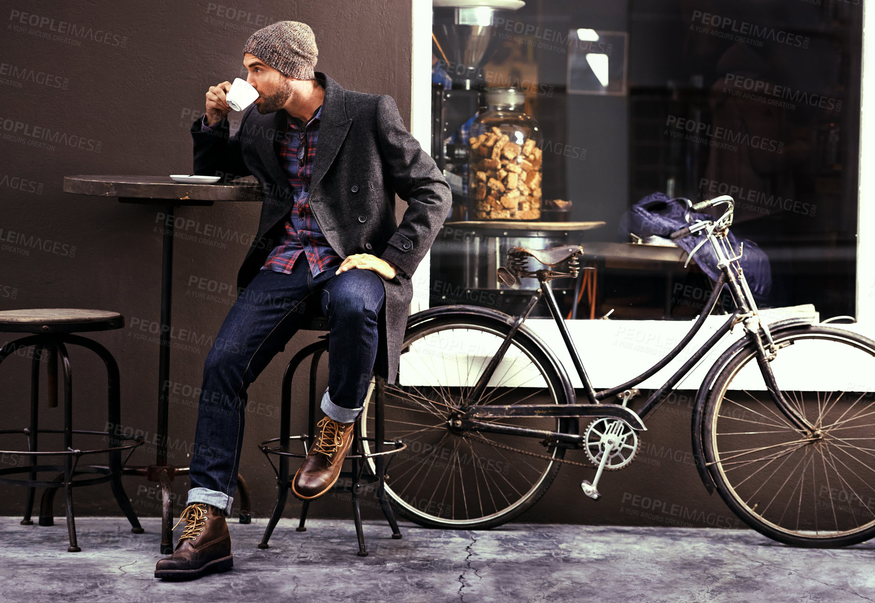 Buy stock photo Relax, cafe and man with a coffee, bike and fashion in the city, sustainable and carbon footprint. Male person, guy and biker with tea, street and outdoor with bicycle and eco friendly transport