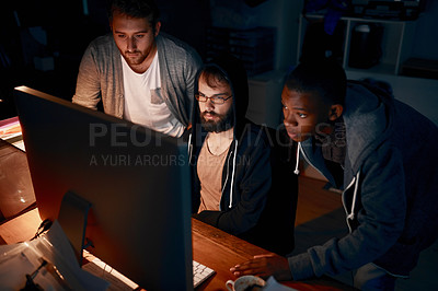 Buy stock photo Cropped shot of young computer programmers working late in the office