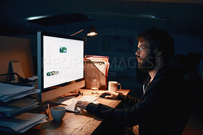 Buy stock photo Cropped shot of a young computer programmer working late in the office