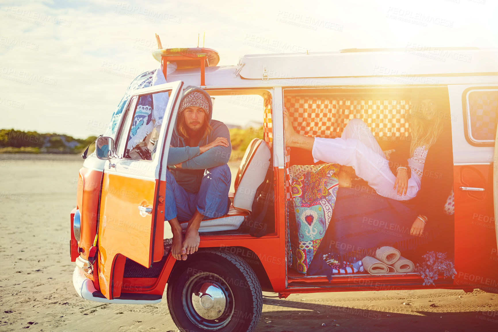 Buy stock photo Shot of an adventurous couple out roadtripping in their mini van