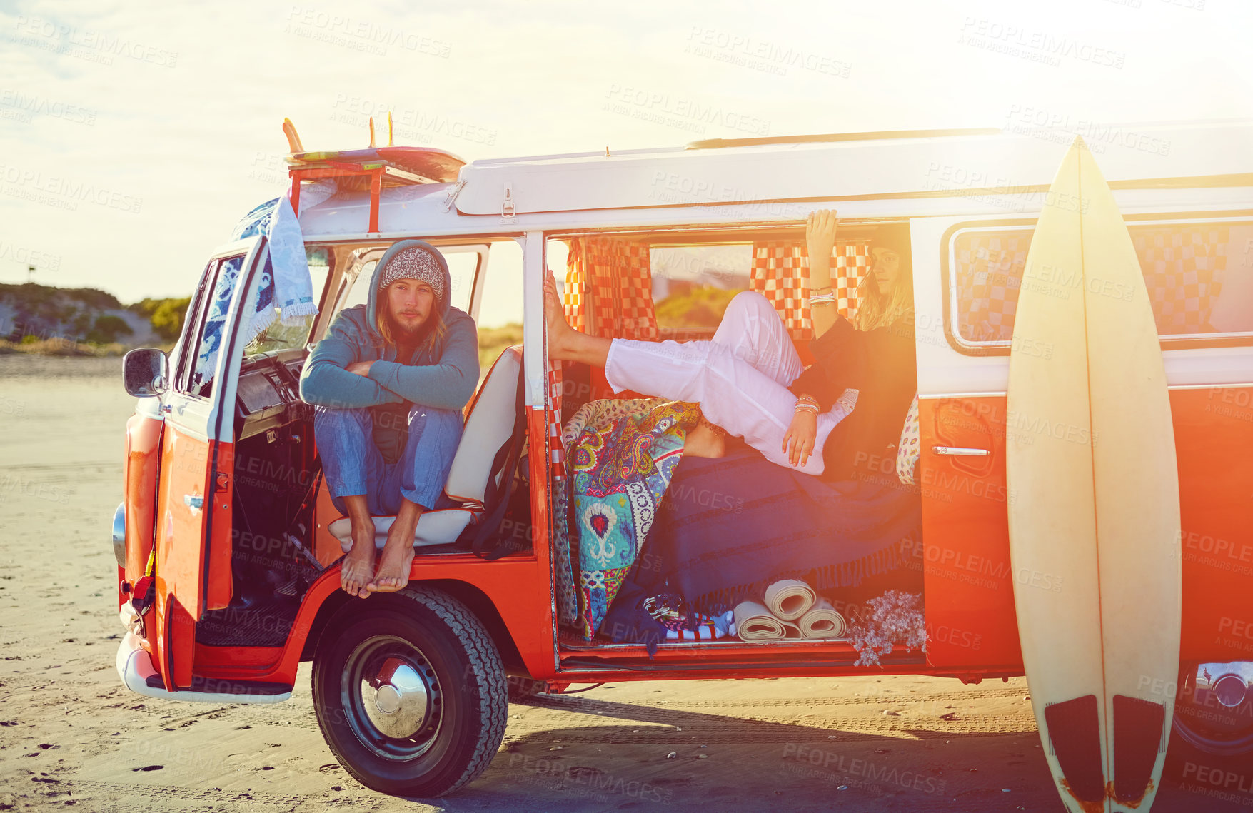 Buy stock photo Shot of an adventurous couple out roadtripping in their mini van