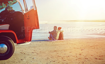 Buy stock photo Shot of a couple admiring the view on the beach while out on a road trip