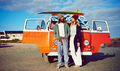 Buy stock photo Shot of an adventurous couple standing in front of their mini van