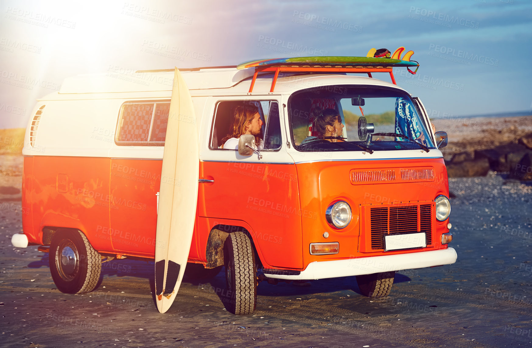 Buy stock photo Shot of an adventurous couple out roadtripping in their mini van