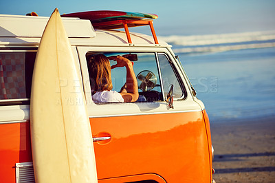 Buy stock photo Shot of a young man out roadtripping in his mini van