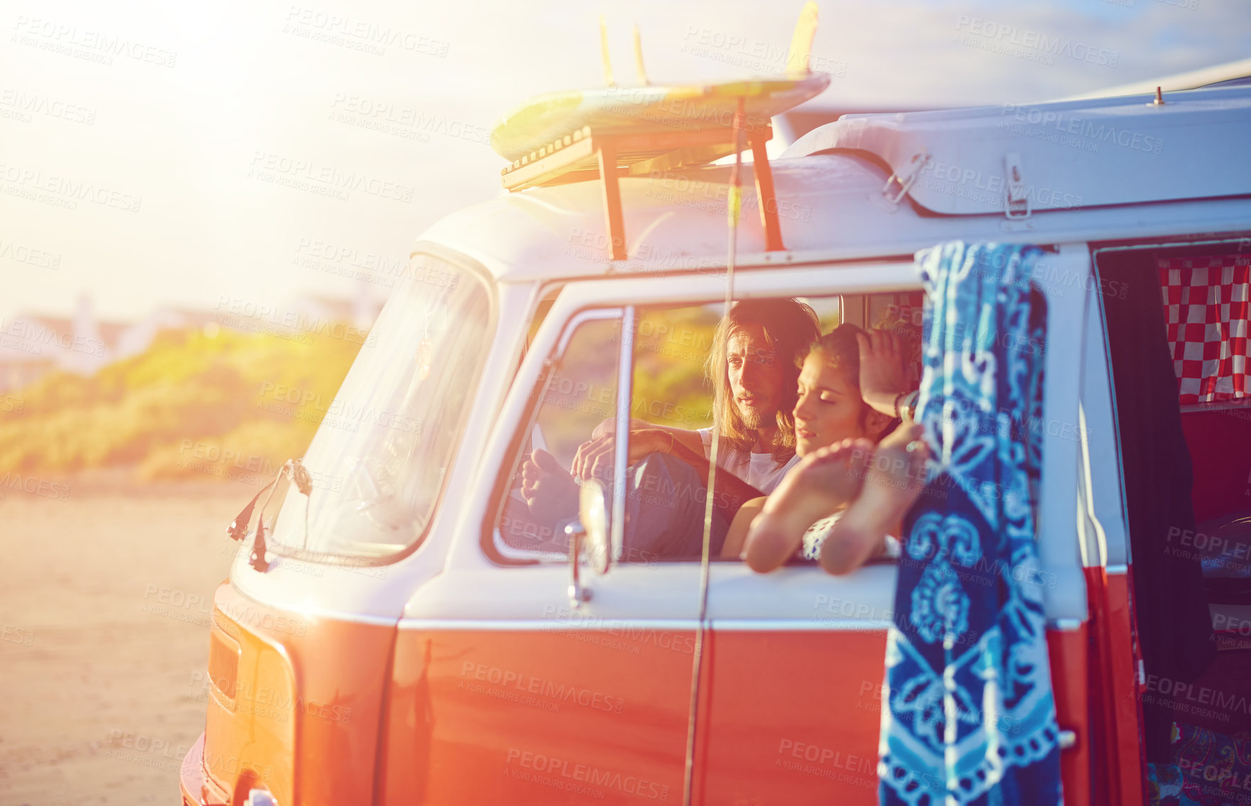 Buy stock photo Shot of an adventurous couple out roadtripping in their mini van