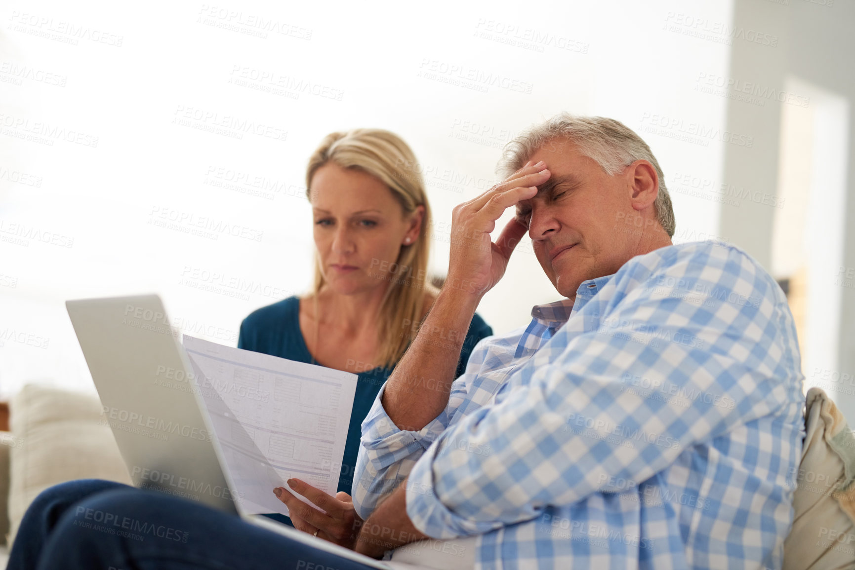 Buy stock photo Cropped shot of a mature couple looking stressed out while doing their budget at home