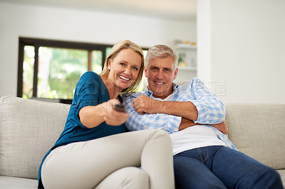 Buy stock photo Cropped shot of a mature couple watching television together at home