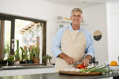 Buy stock photo Cropped portrait of a mature man cooking a healthy meal at home