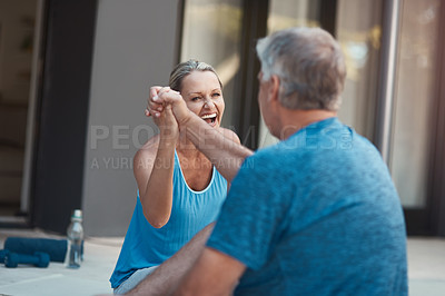 Buy stock photo Shot of a mature and motivated couple congratulating each other on the end of a tough exercise