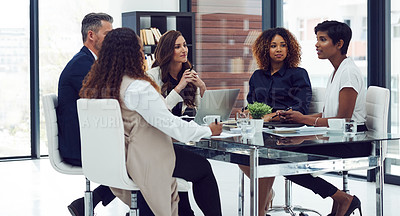 Buy stock photo Cropped shot of a group of corporate colleagues sitting in the boardroom