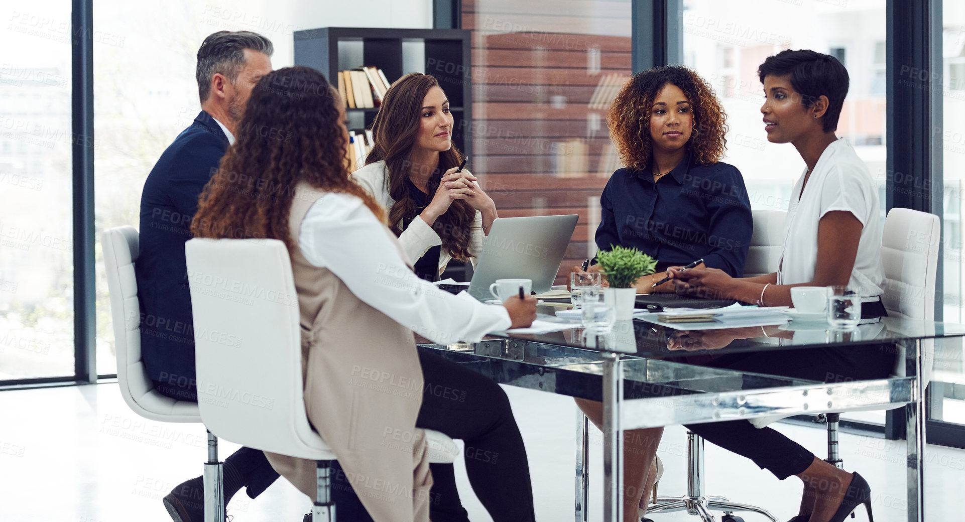 Buy stock photo Cropped shot of a group of corporate colleagues sitting in the boardroom