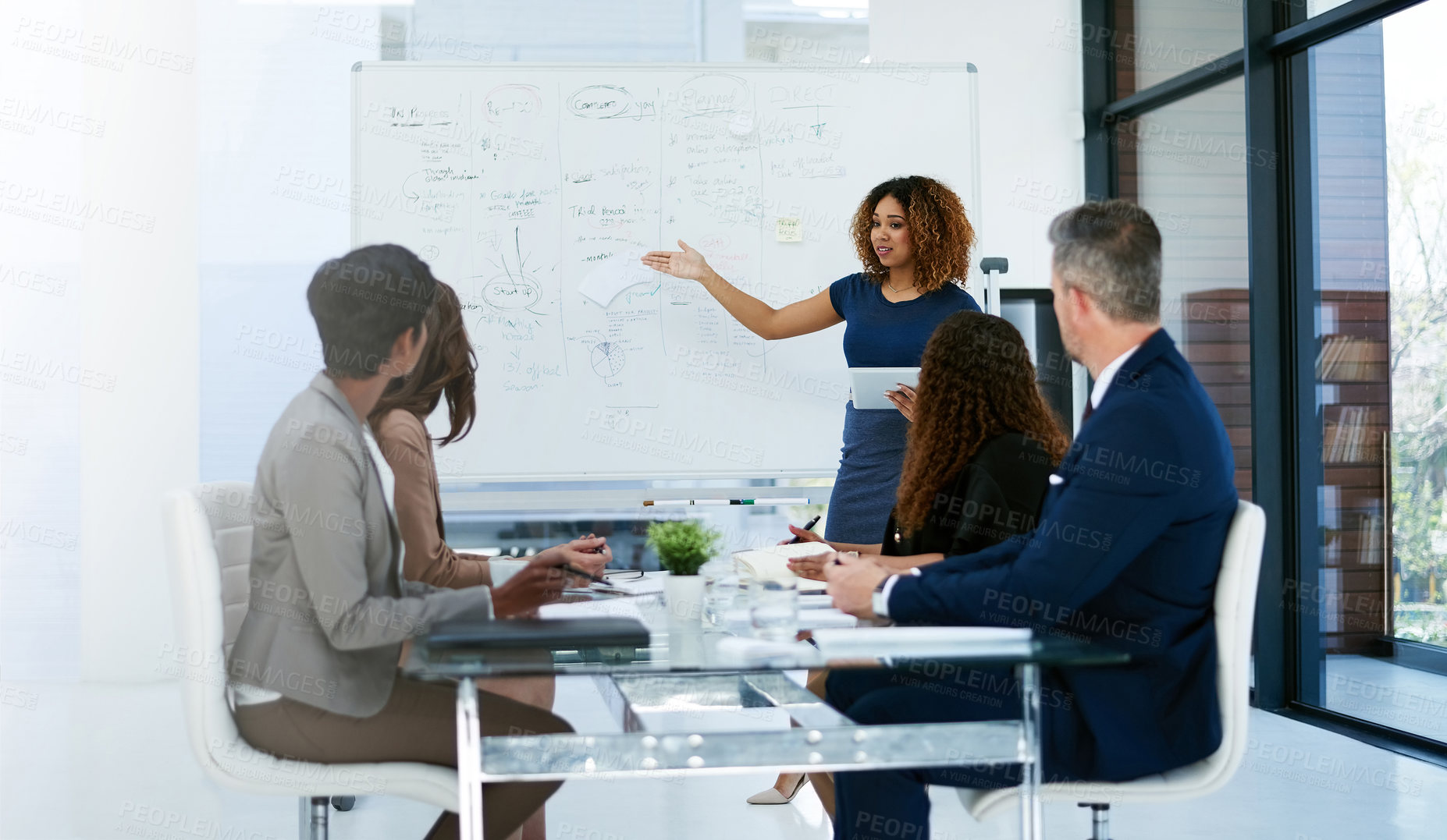 Buy stock photo Cropped shot of a young businesswoman giving a presentation in the boardroom