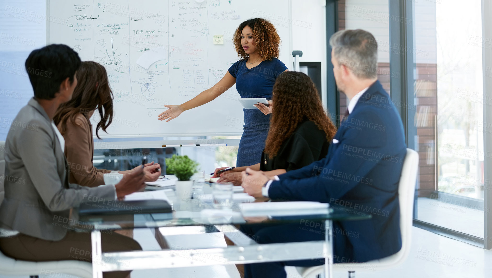 Buy stock photo Cropped shot of a young businesswoman giving a presentation in the boardroom