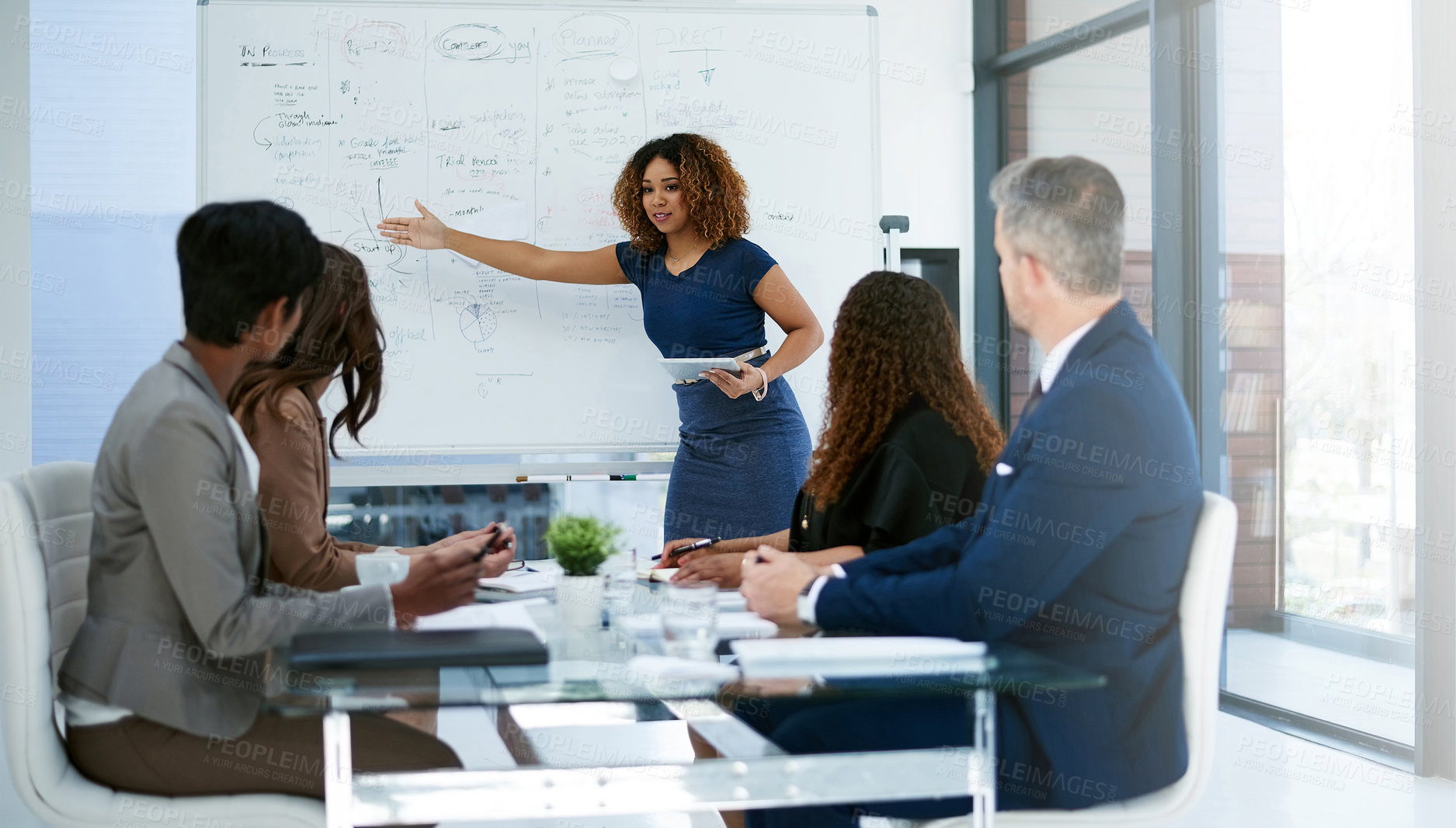 Buy stock photo Cropped shot of a young businesswoman giving a presentation in the boardroom