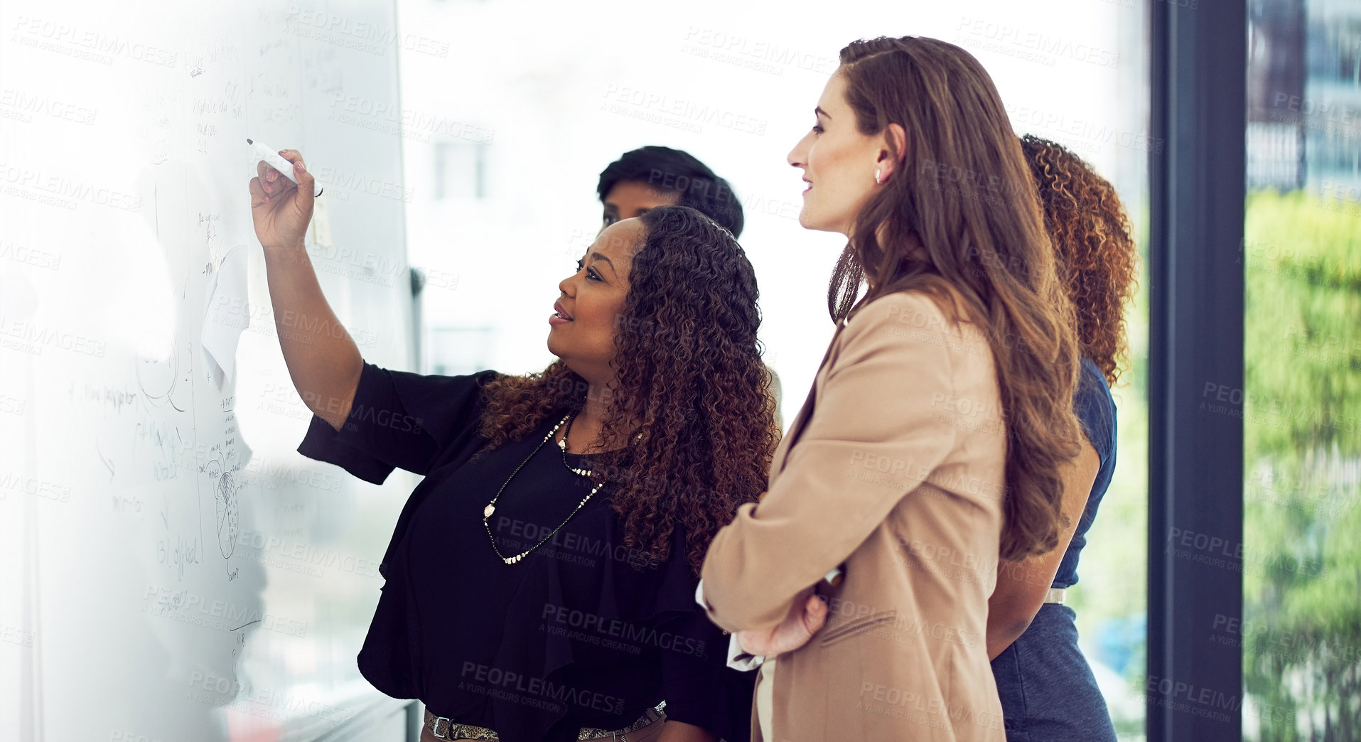 Buy stock photo Cropped shot of a group of businesswomen working on a whiteboard in the boardroom