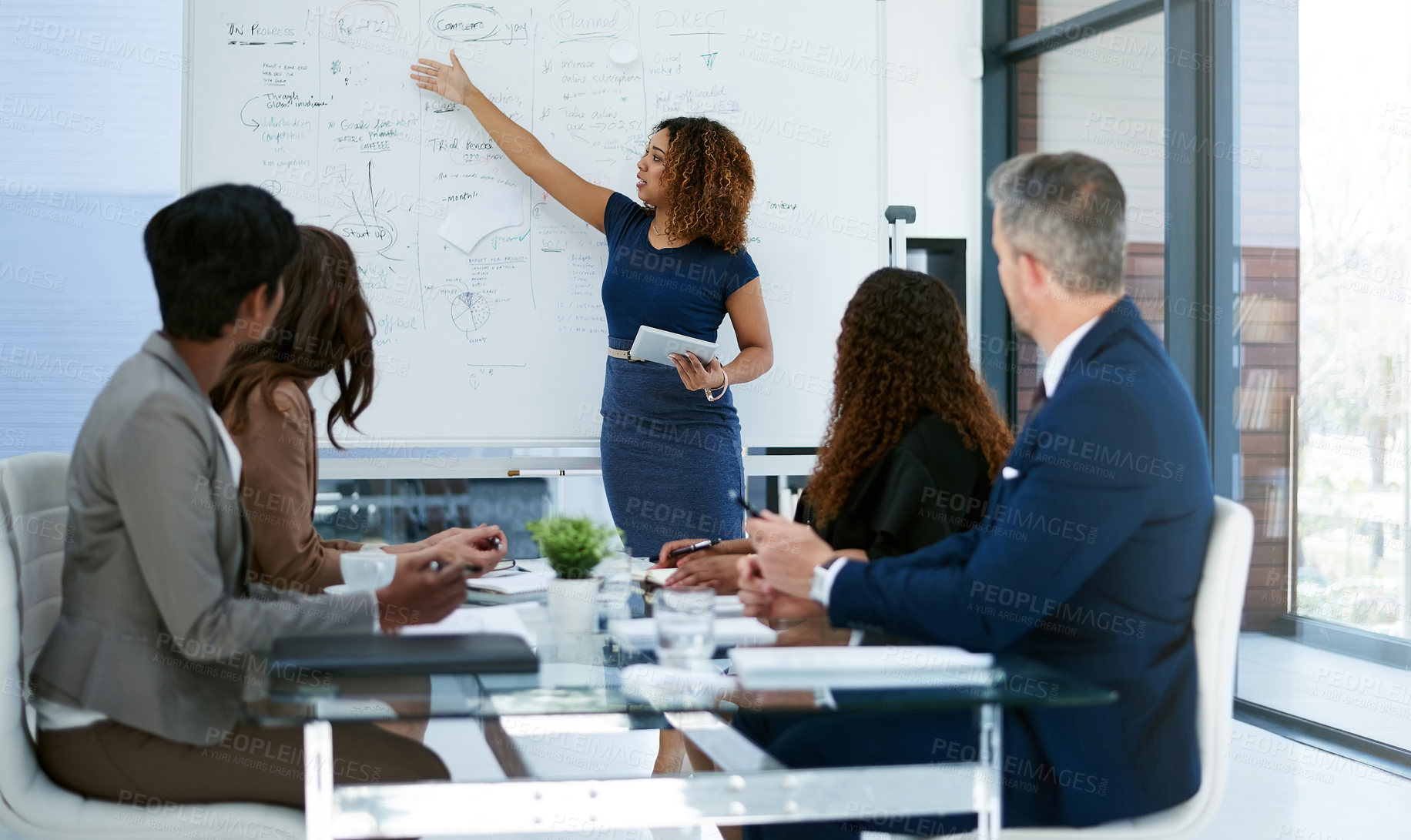 Buy stock photo Cropped shot of a young businesswoman giving a presentation in the boardroom