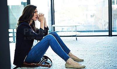 Buy stock photo Shot of a stressed businesswoman sitting on the floor outside the boardroom