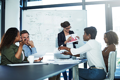 Buy stock photo Shot of a group of focussed businesspeople attending a colleague's presentation in the boardroom