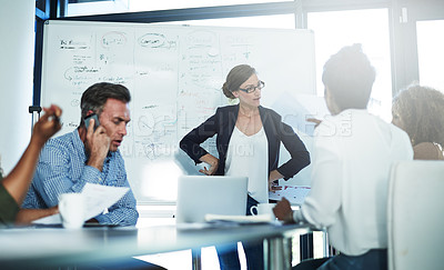 Buy stock photo Shot of a stressed businesswoman losing her temper during a meeting with her colleagues in the boardroom