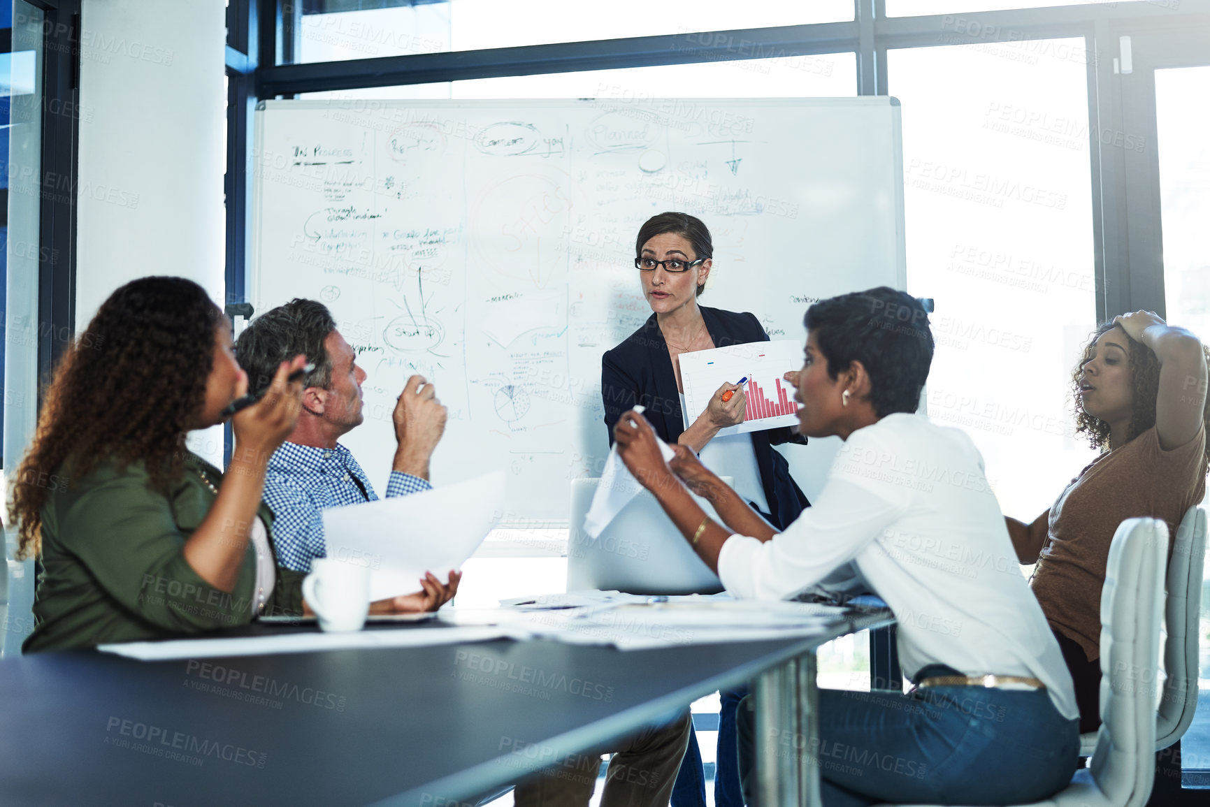 Buy stock photo Shot of a stressed businesswoman losing her temper during a meeting with her colleagues in the boardroom