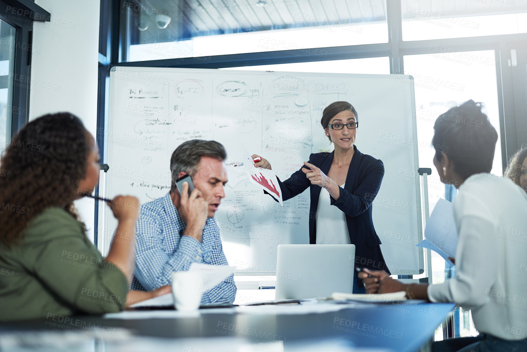 Buy stock photo Shot of a group of focussed businesspeople attending a colleague's presentation in the boardroom