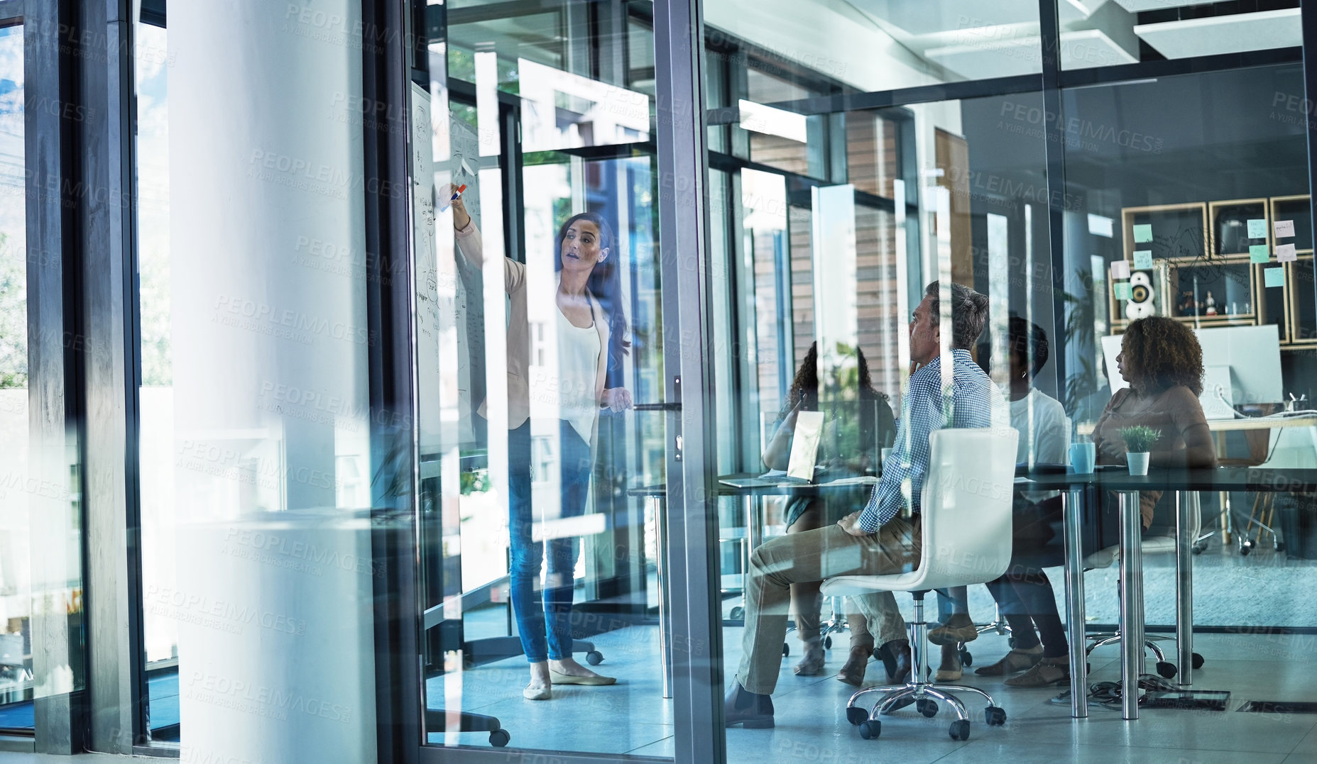 Buy stock photo Shot of a group of focussed businesspeople listening to a presentation in the boardroom