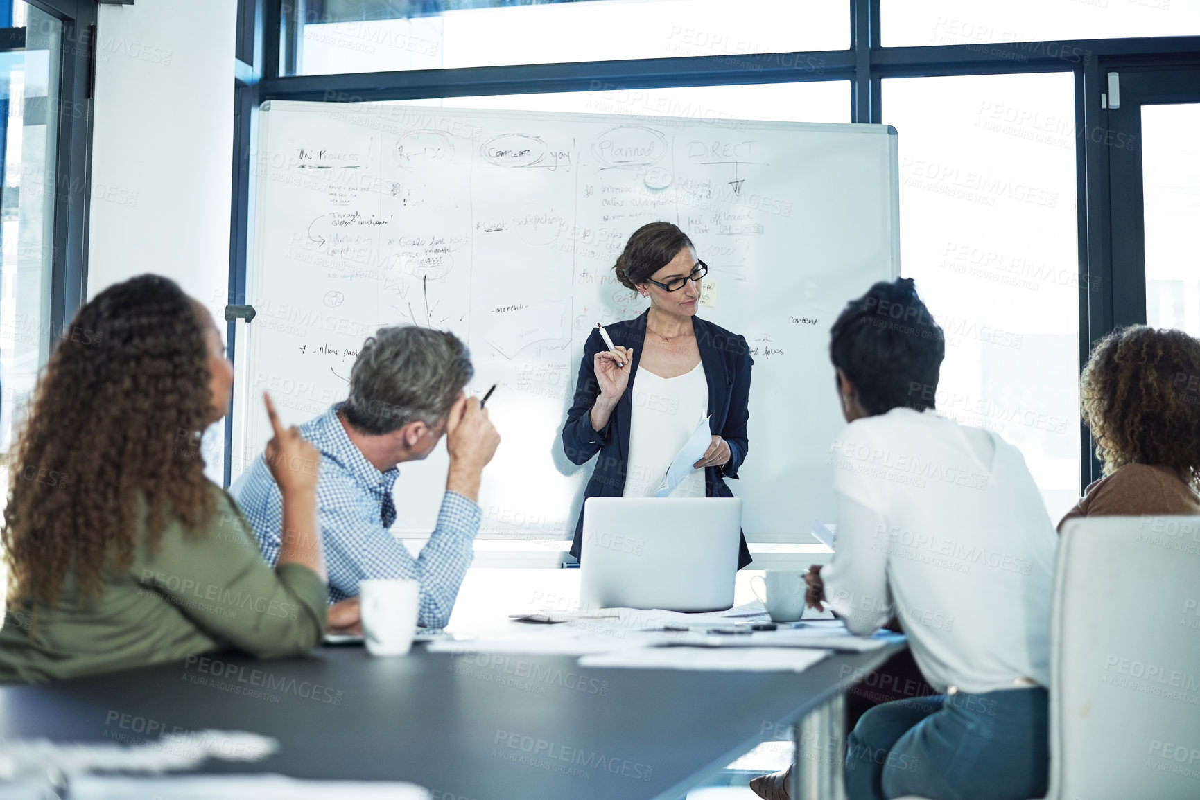 Buy stock photo Shot of a group of focussed businesspeople attending a colleague's presentation in the boardroom