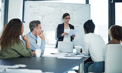Buy stock photo Shot of a group of focussed businesspeople attending a colleague's presentation in the boardroom