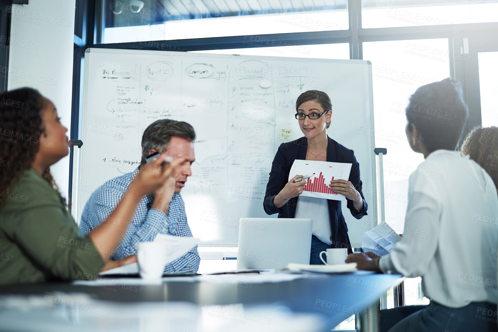 Buy stock photo Shot of a stressed businesswoman losing her temper during a meeting with her colleagues in the boardroom