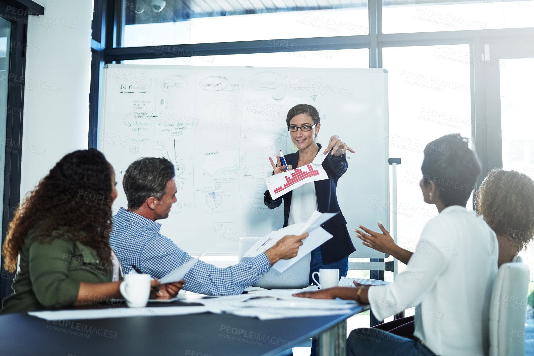 Buy stock photo Shot of a stressed businesswoman losing her temper during a meeting with her colleagues in the boardroom