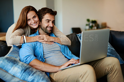 Buy stock photo Cropped shot of an affectionate young couple relaxing on the sofa at home
