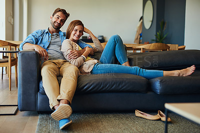 Buy stock photo Full length portrait of an affectionate young couple relaxing on the sofa at home