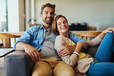 Buy stock photo Cropped portrait of an affectionate young couple relaxing on the sofa at home