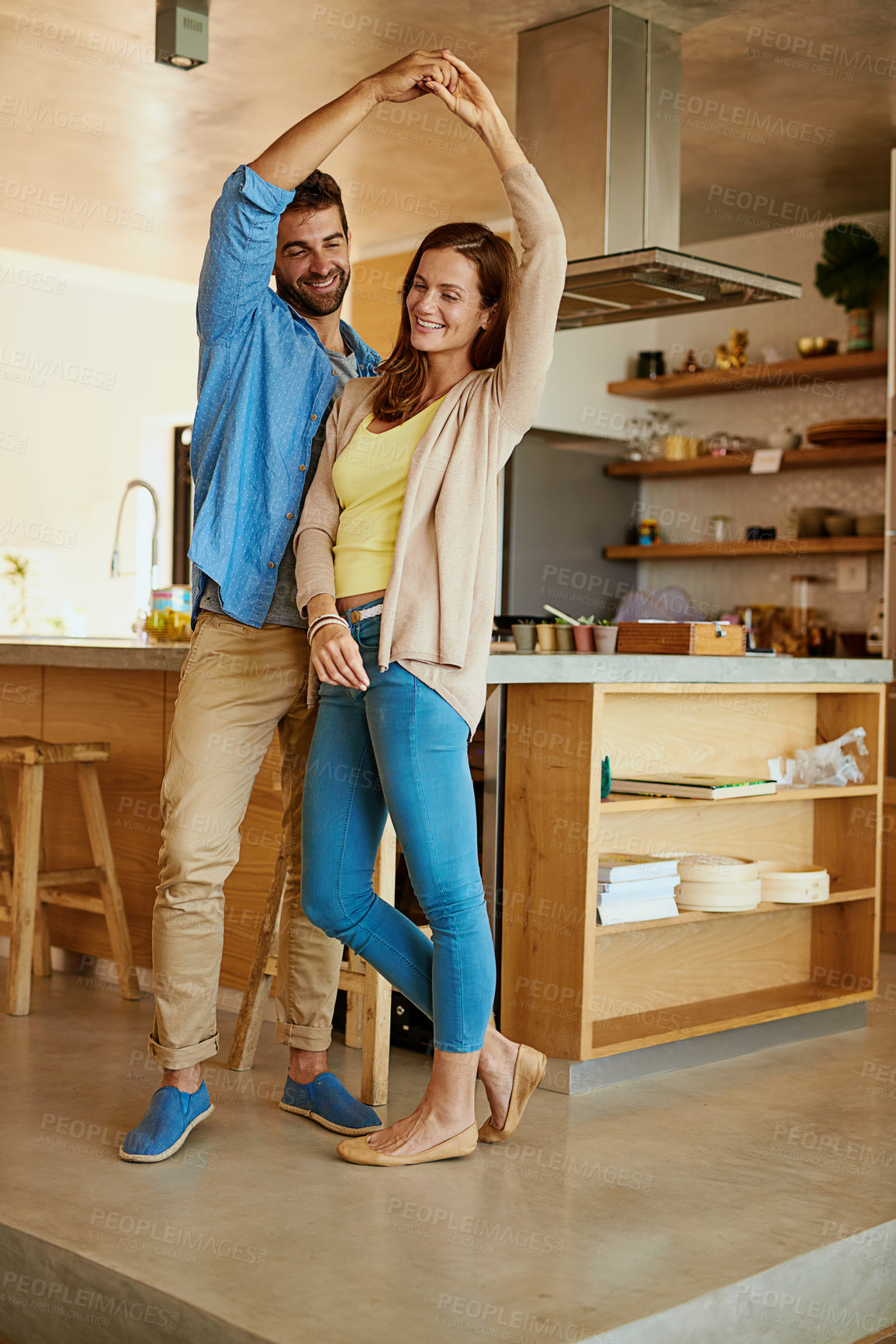 Buy stock photo Couple, dancing and together in home for wellness, happiness for anniversary or date. Man, woman and twirl movement in kitchen with support and disco music, partners with commitment and smile