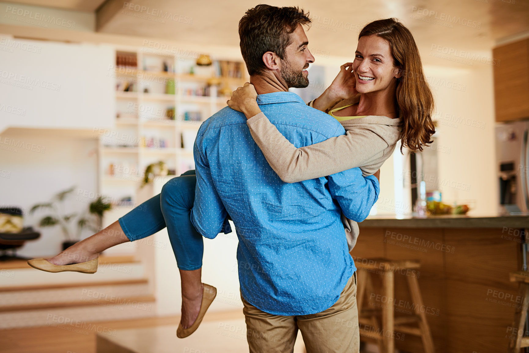 Buy stock photo Couple, carrying and smile in new home, portrait and mortgage for people from honeymoon, together and relationship. Moving, man and woman in house with loan, marriage and investing with partner