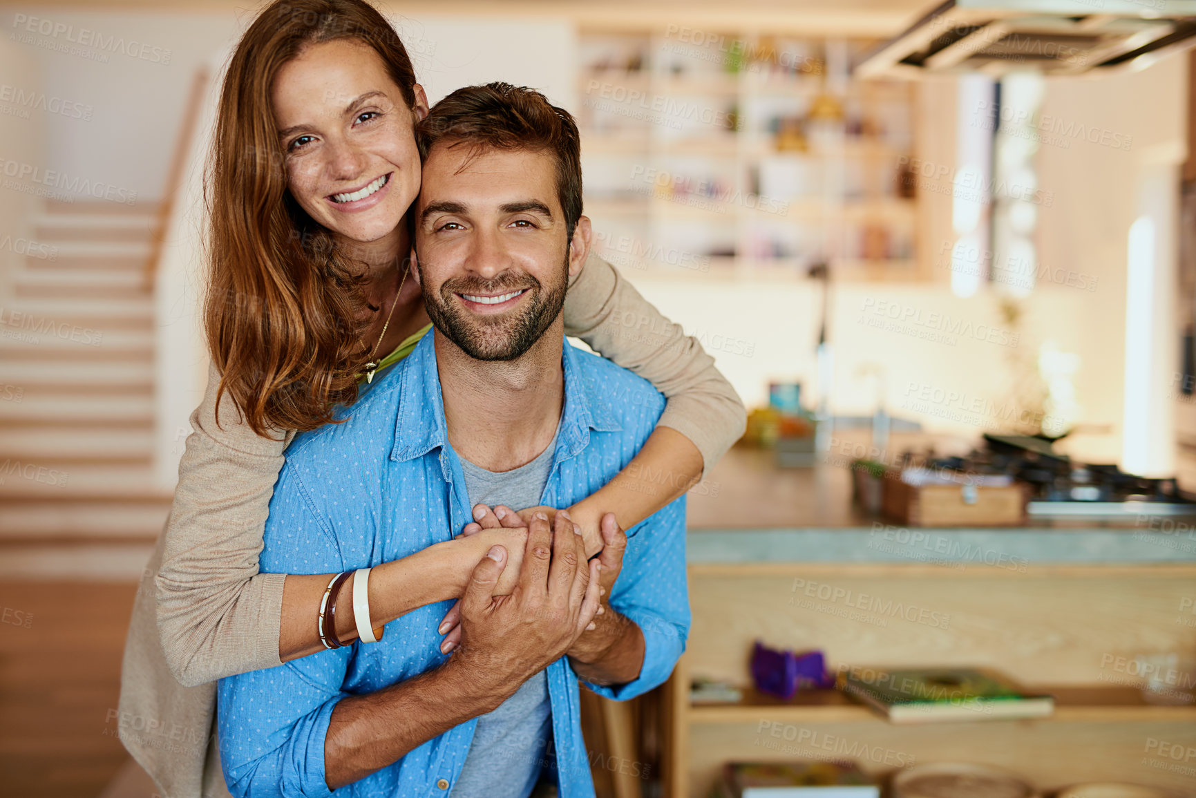 Buy stock photo Cropped portrait of an affectionate young couple standing in their kitchen